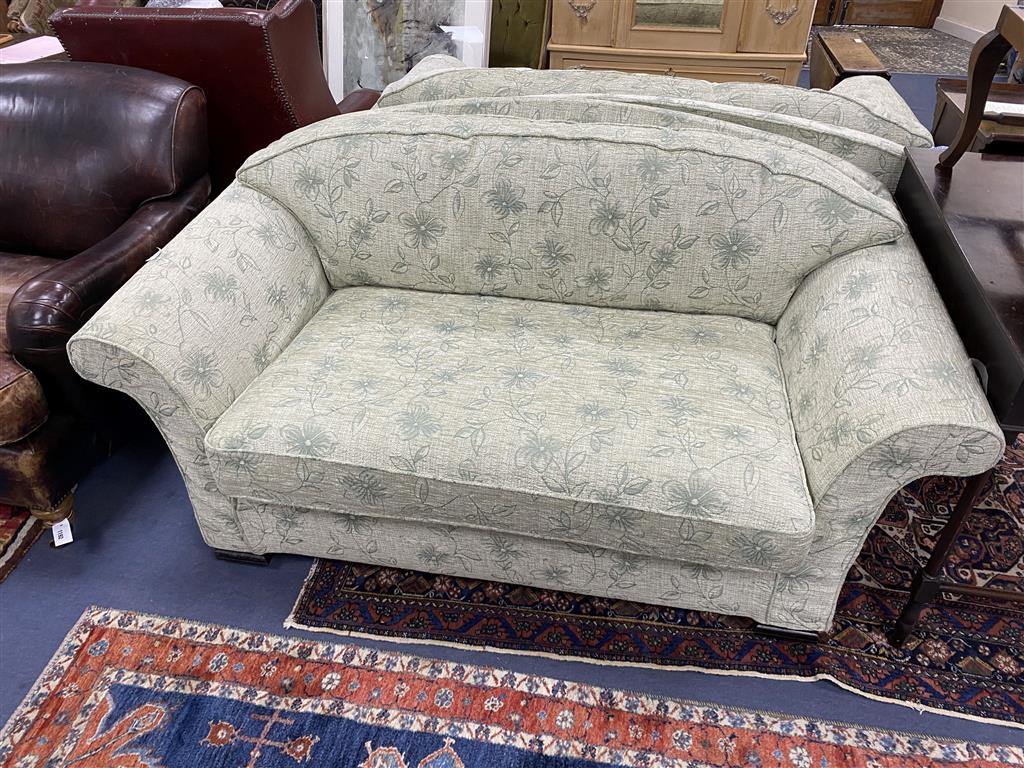 A pair of modern green floral upholstered two seater settees, length 164cm, depth 93cm, height 82cm